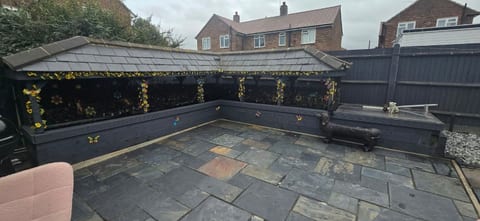 Raised sleeper pond under a covered pergola in a Gillingham garden, after a full clean