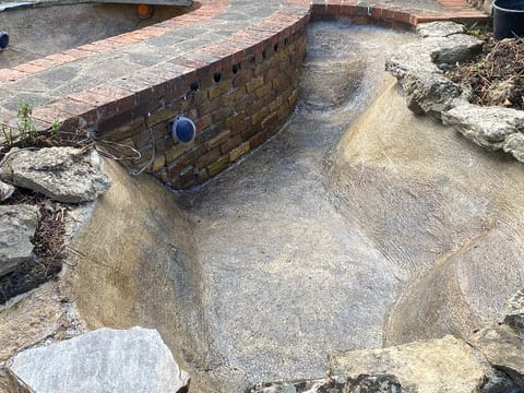 Concrete garden pond in Hastings drained and cleaned out during a full clean