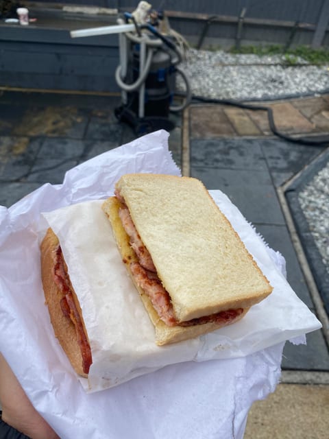 A bacon sandwich from the customer, with my pond vacuum in the background