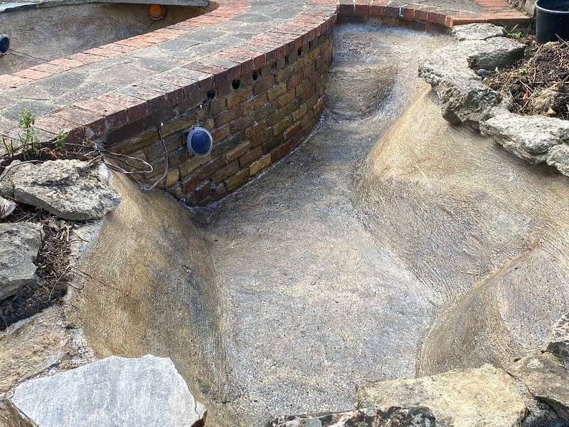 Concrete garden pond in Hastings drained and cleaned out during a full clean
